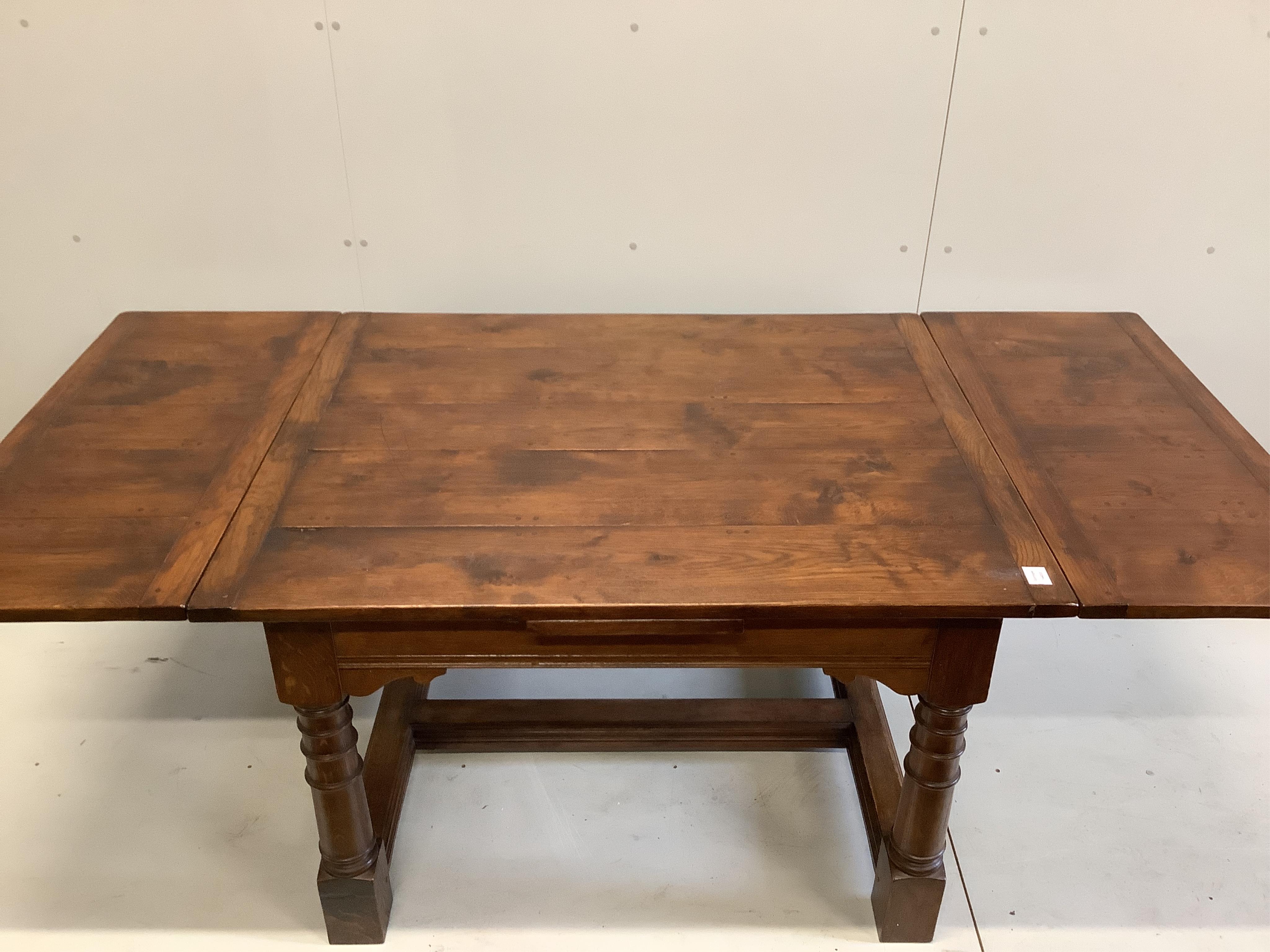 An 18th century style rectangular oak draw leaf refectory dining table, width 121cm, 210cm extended, depth 101cm, height 78cm. Condition - good
